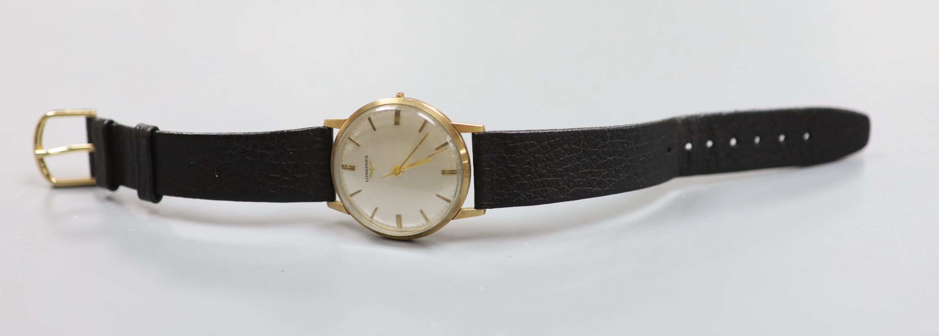 A gentleman's 1960's 9ct gold Longines manual wind wrist watch (lacking winding crown), with case back inscription.